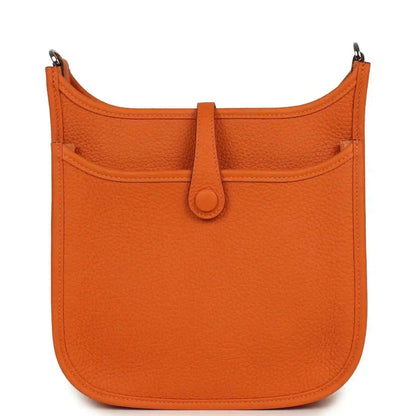 Orange leather hobo bag back view with top handle and center snap button