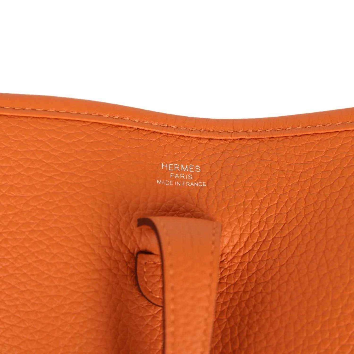 Orange leather bag label with HERMÈS PARIS and MADE IN FRANCE text