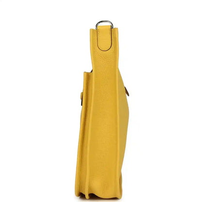 Yellow leather crossbody bag side view with metal ring hardware and strap loop