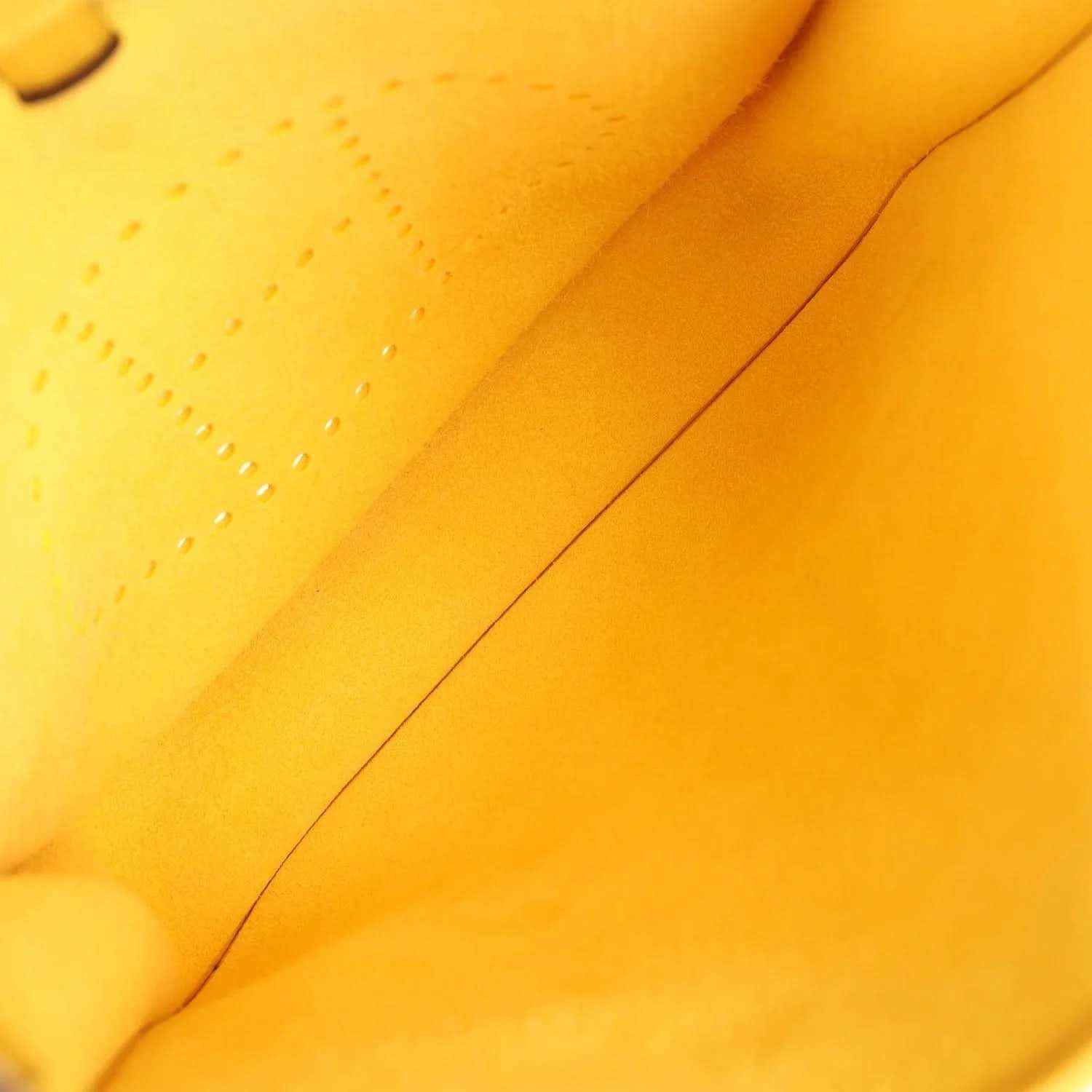 Yellow leather interior seam close-up with smooth finish and stitching line