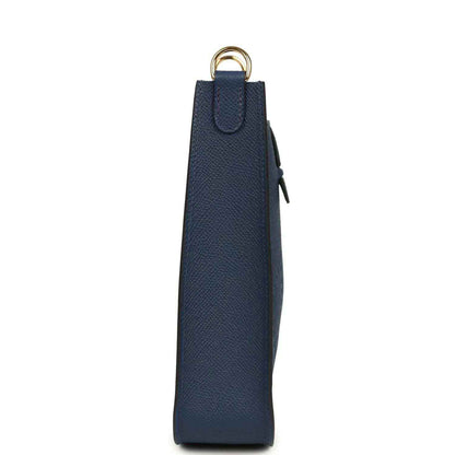 Hermes bag in blue with side panel, dangling tag, and gold-tone top ring