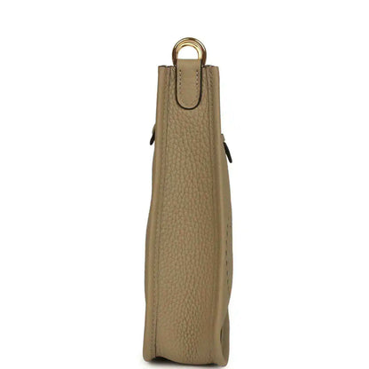 Beige pebbled leather Evelyne TPM bag back view with top handle and small pull tabs
