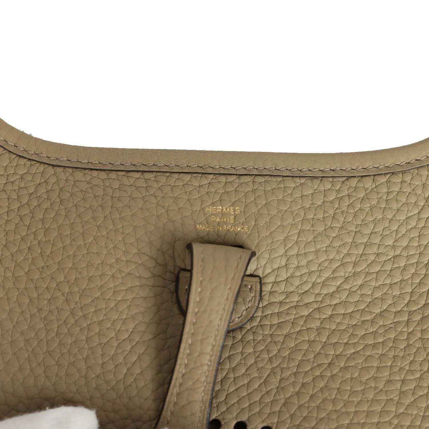 Beige pebbled leather bag interior with Hermes Paris stamp on leather tab