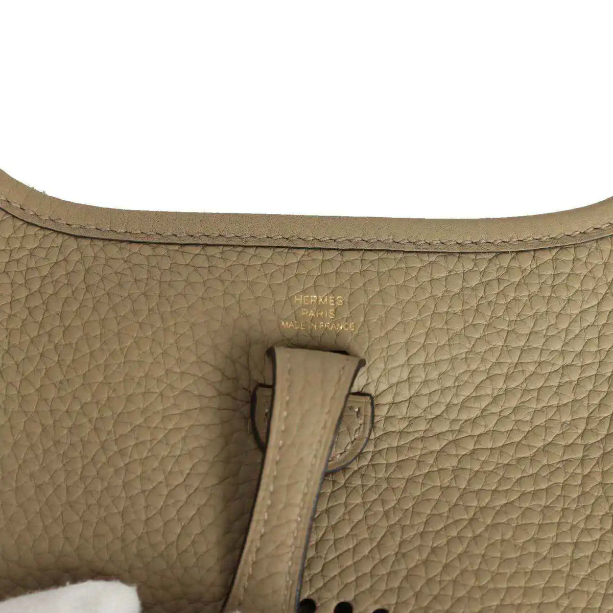Beige pebbled leather bag interior with Hermes Paris stamp on leather tab
