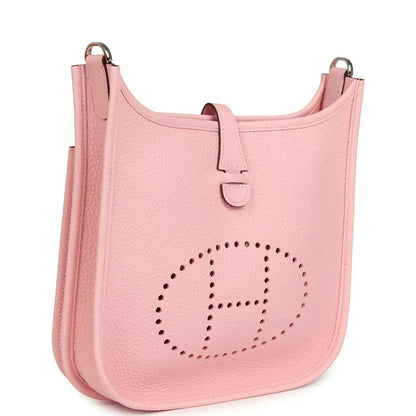 Hermes Evelyne 23 bag in rose pink leather, side view with dotted H logo and strap