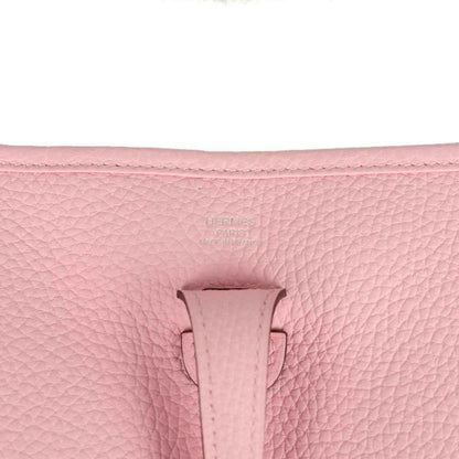 Hermes Evelyne 23 bag in rose pink leather, close-up of front tab and textured grain