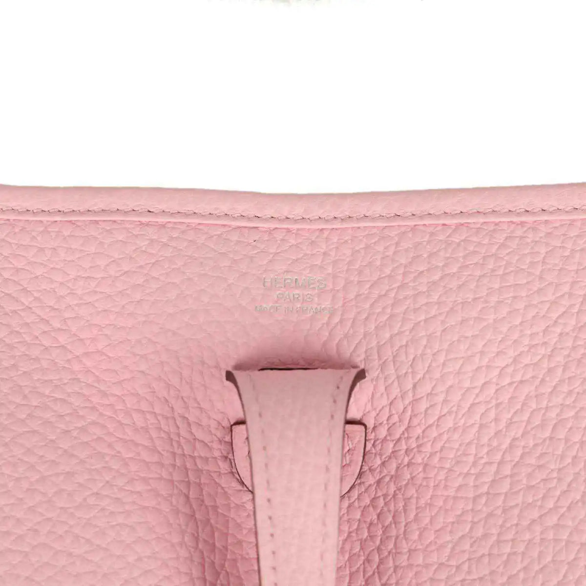 Hermes Evelyne 23 bag in rose pink leather, close-up of front tab and textured grain