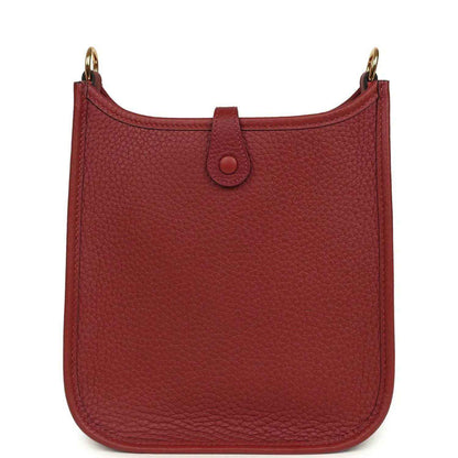 Red textured leather small bag with top handle and front tab closure detail