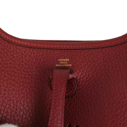 Red textured leather bag with Hermès Paris stamp and Made in France marking
