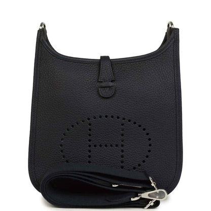 Black leather crossbody bag with perforated logo and wrap strap detail