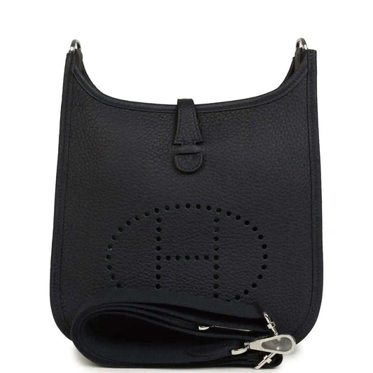 Black leather crossbody bag with perforated logo and wrap strap detail