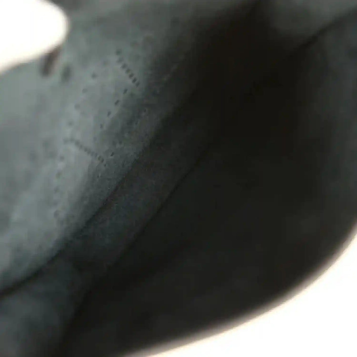 Black leather bag interior lining with smooth fabric and curved edge