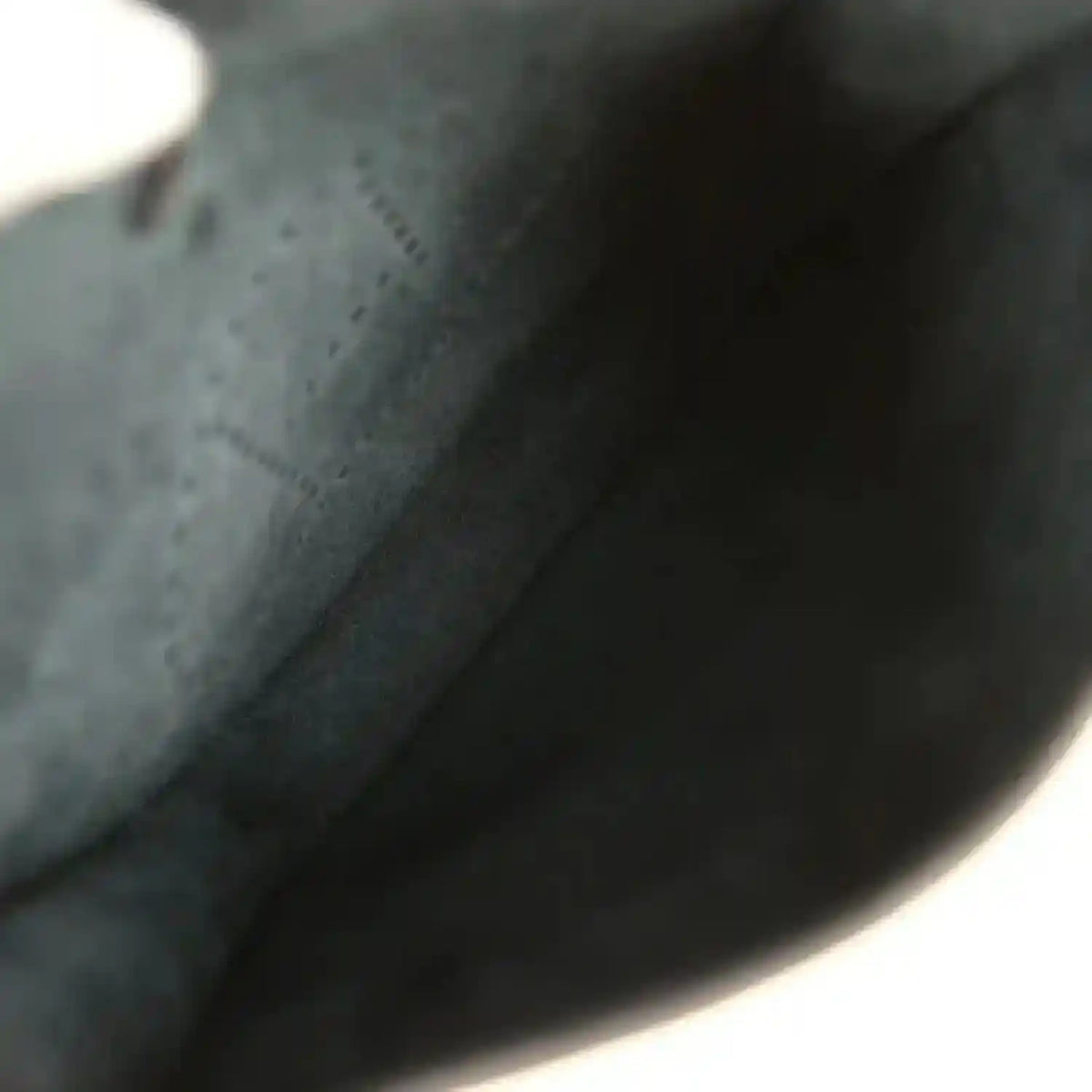 Black leather bag interior lining with smooth fabric and curved edge
