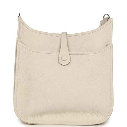 Hermes Evelyne III PM messenger bag in light beige leather, front view with clasp strap