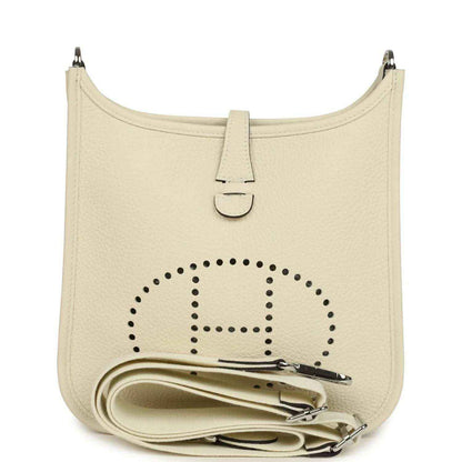 Cream leather shoulder bag with perforated logo front and front tab closure