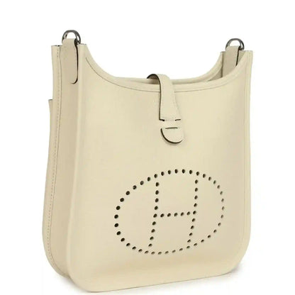 Cream leather shoulder bag with perforated logo panel and top handles