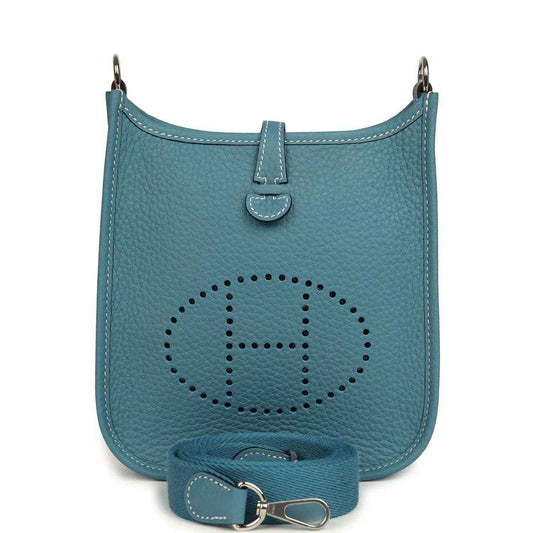 Blue denim leather mini messenger bag with perforated logo and adjustable strap