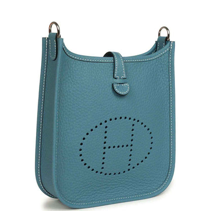 Blue denim leather mini messenger bag with perforated oval logo and top handles