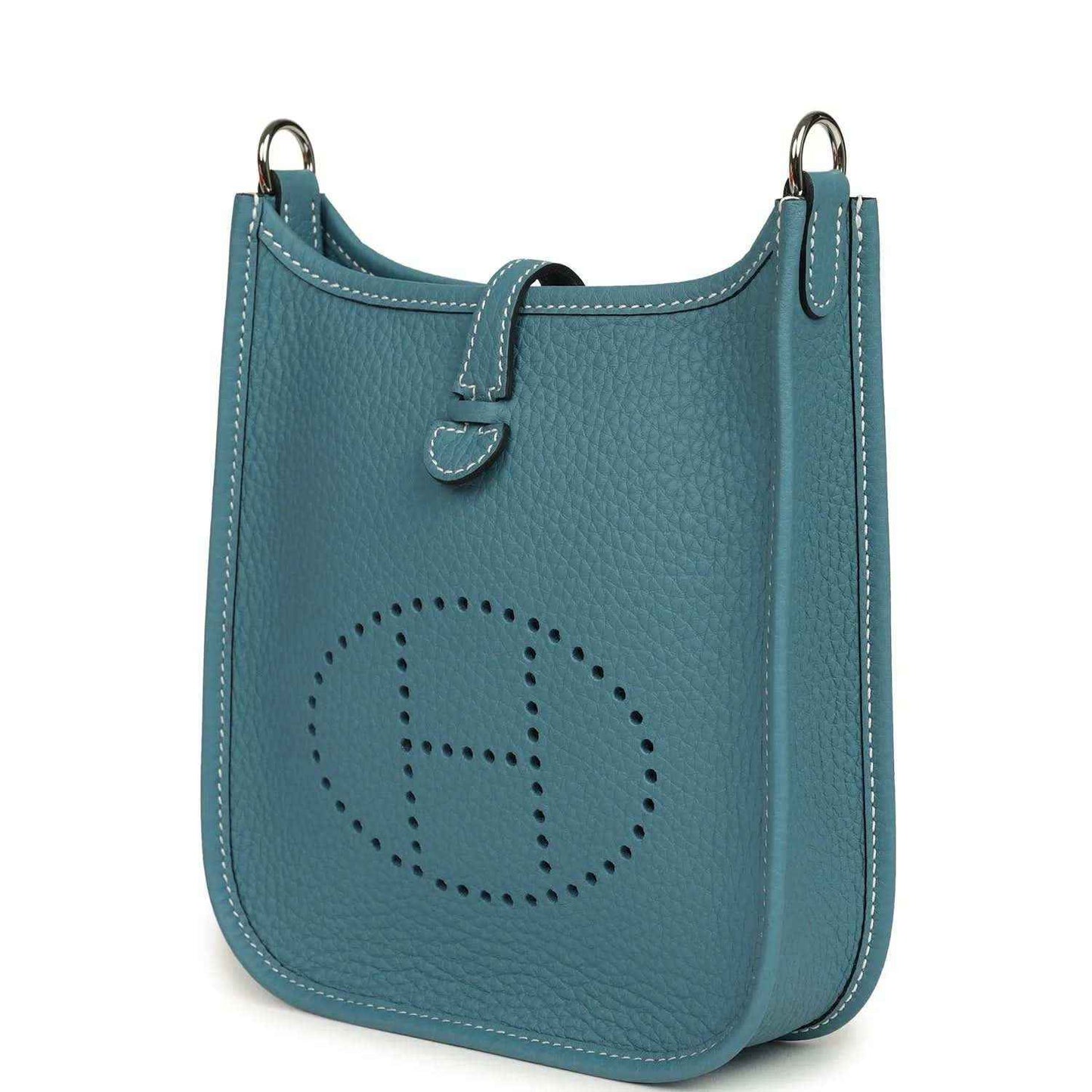 Blue denim leather mini messenger bag with perforated oval logo and side handle