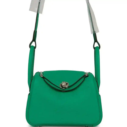 Mini green leather handbag with top handle and silver-tone clasp