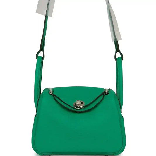 Mini green leather handbag with top handle and silver-tone clasp