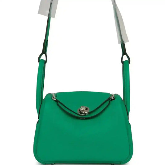 Mini green leather handbag with top handle and silver-tone clasp