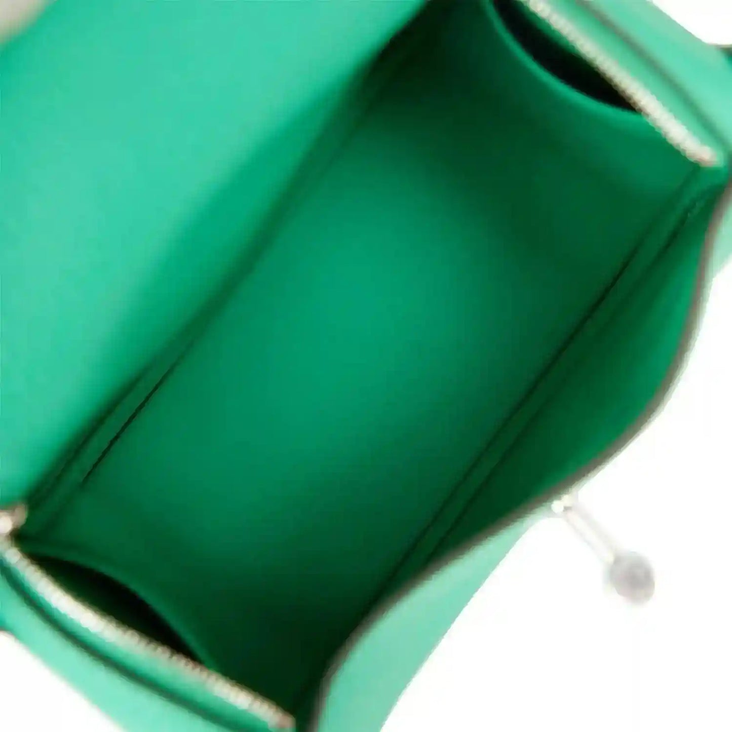 Mini green leather handbag interior with stitched lining and metal trim