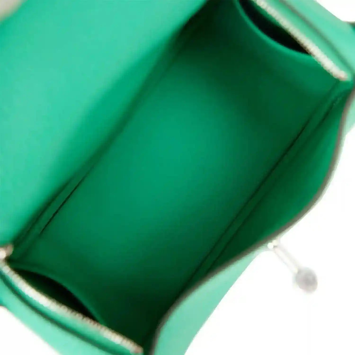 Mini green leather handbag interior with stitched lining and metal trim