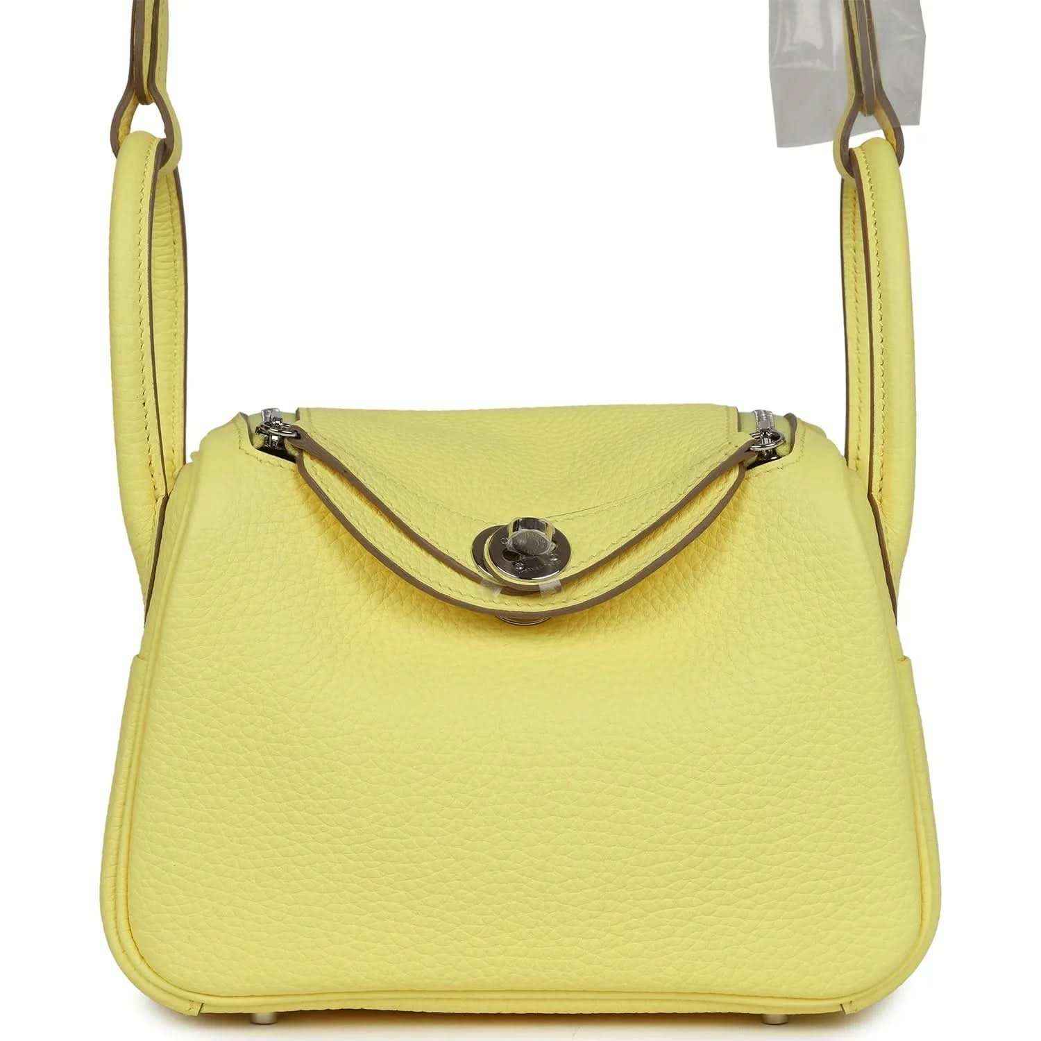 Hermes mini Lindy handbag in textured yellow leather, top flap with metal clasp.