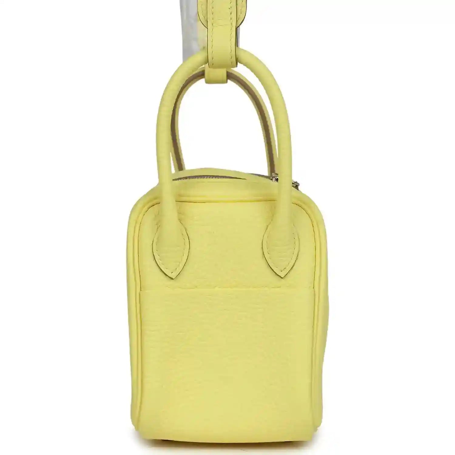 Hermes mini Lindy handbag in textured yellow leather, view of top handles.