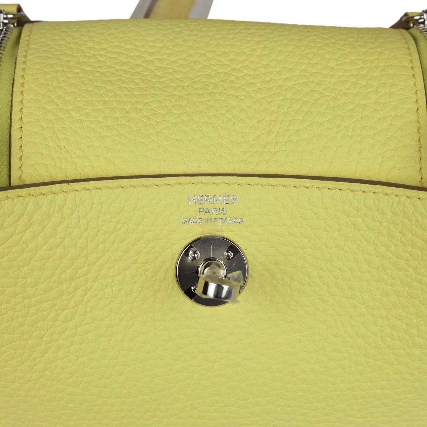 Hermes mini Lindy handbag in textured yellow leather, front flap snap and stamping.