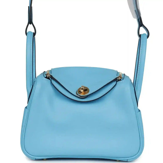 Mini handbag in light blue leather with top handle and gold-tone clasp hardware