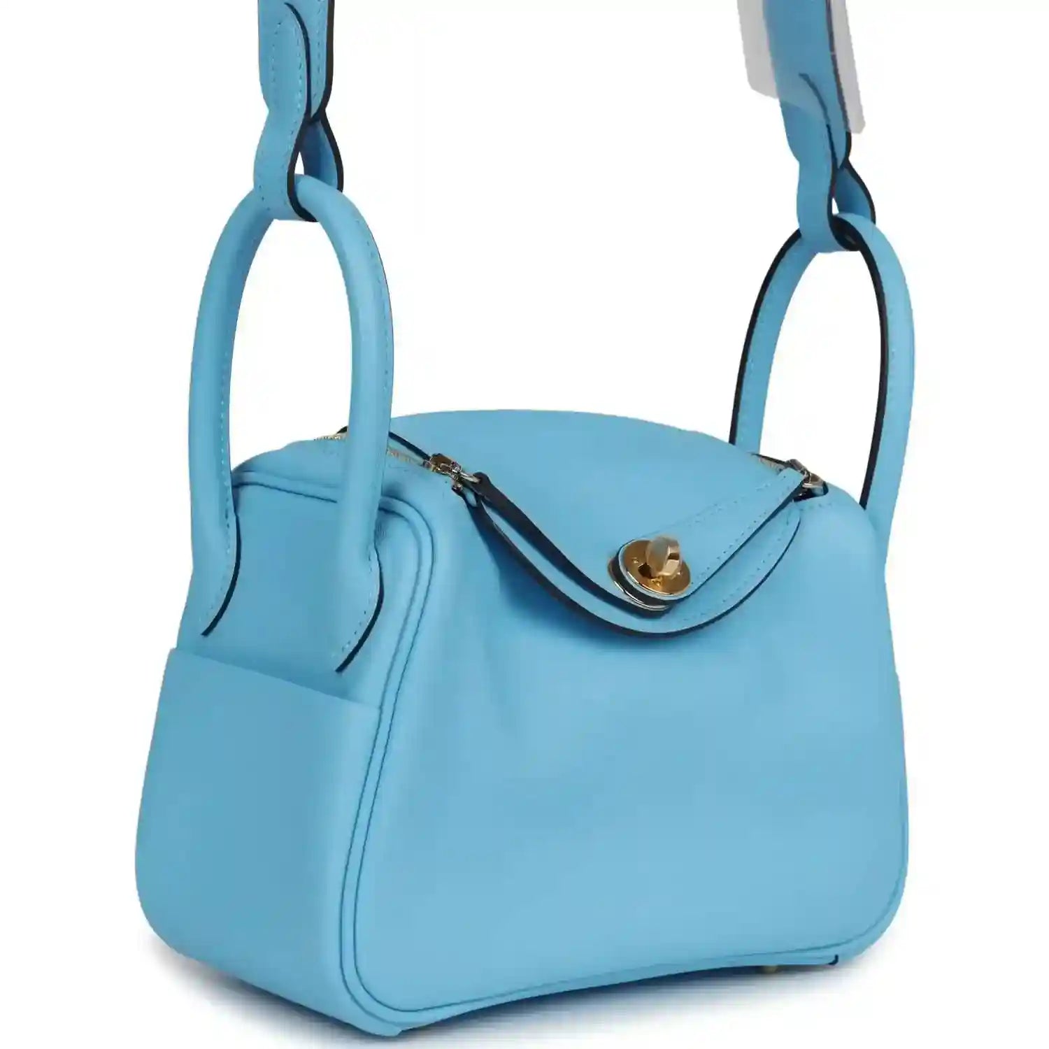 Mini light blue leather handbag with curved top flap and gold-tone clasp