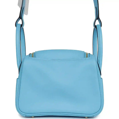 Light blue leather mini handbag with top opening edge and two carry handles