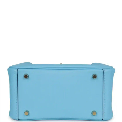 Light blue leather mini handbag with round hardware studs on the base