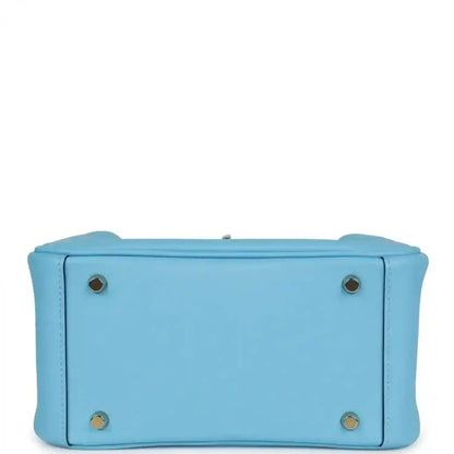 Light blue leather mini handbag with round hardware studs on the base