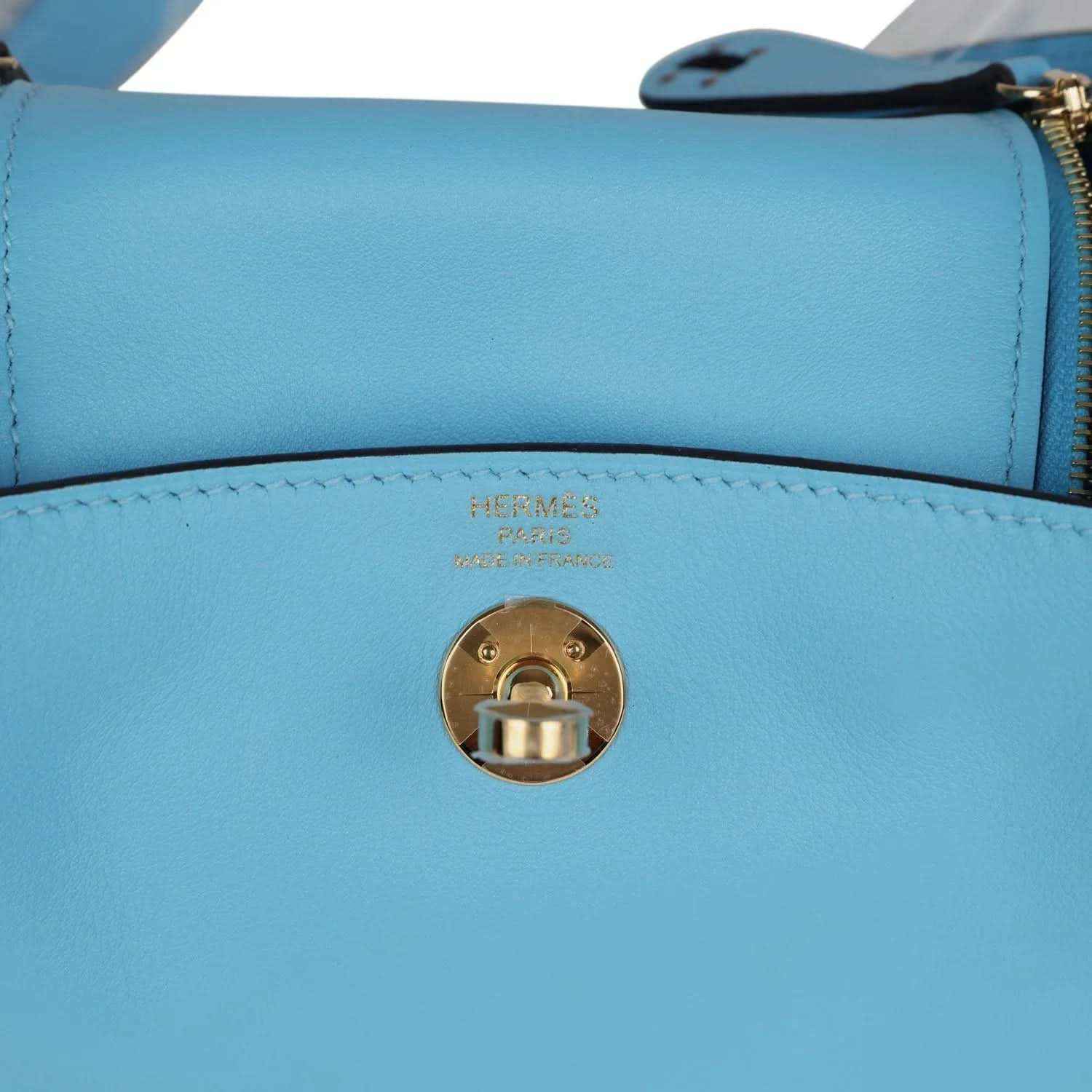 Mini handbag turn-lock clasp with Hermes logo on light blue leather