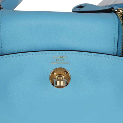 Mini handbag turn-lock clasp with Hermes logo on light blue leather
