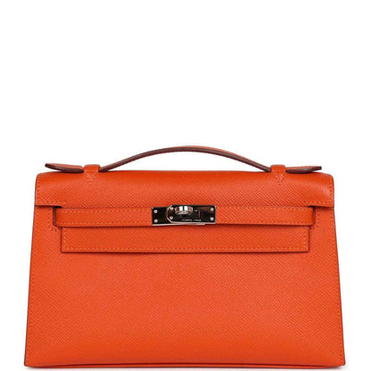 Orange Epsom leather clutch with top handle and front flap, silver-tone lock hardware