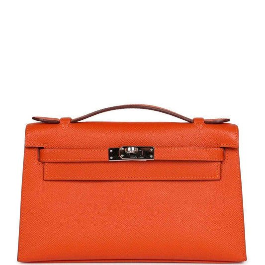Orange Epsom leather clutch with top handle and front flap, silver-tone lock hardware