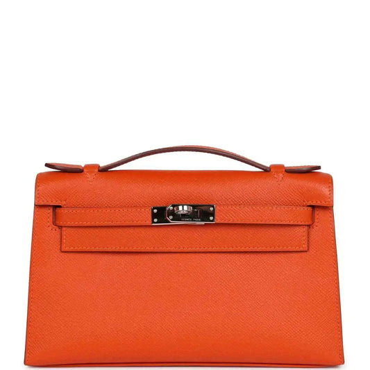 Orange Epsom leather clutch with top handle and front flap, silver-tone lock hardware