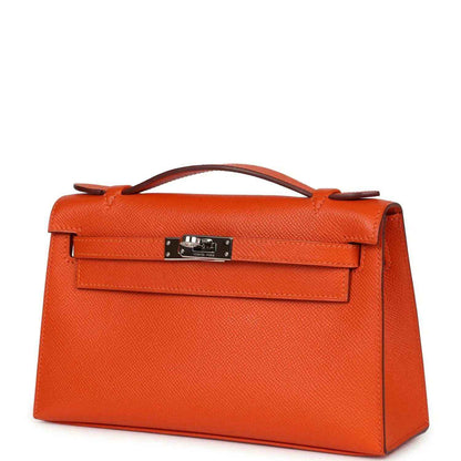 Orange Epsom leather Kelly clutch with front flap and silver-tone lock hardware