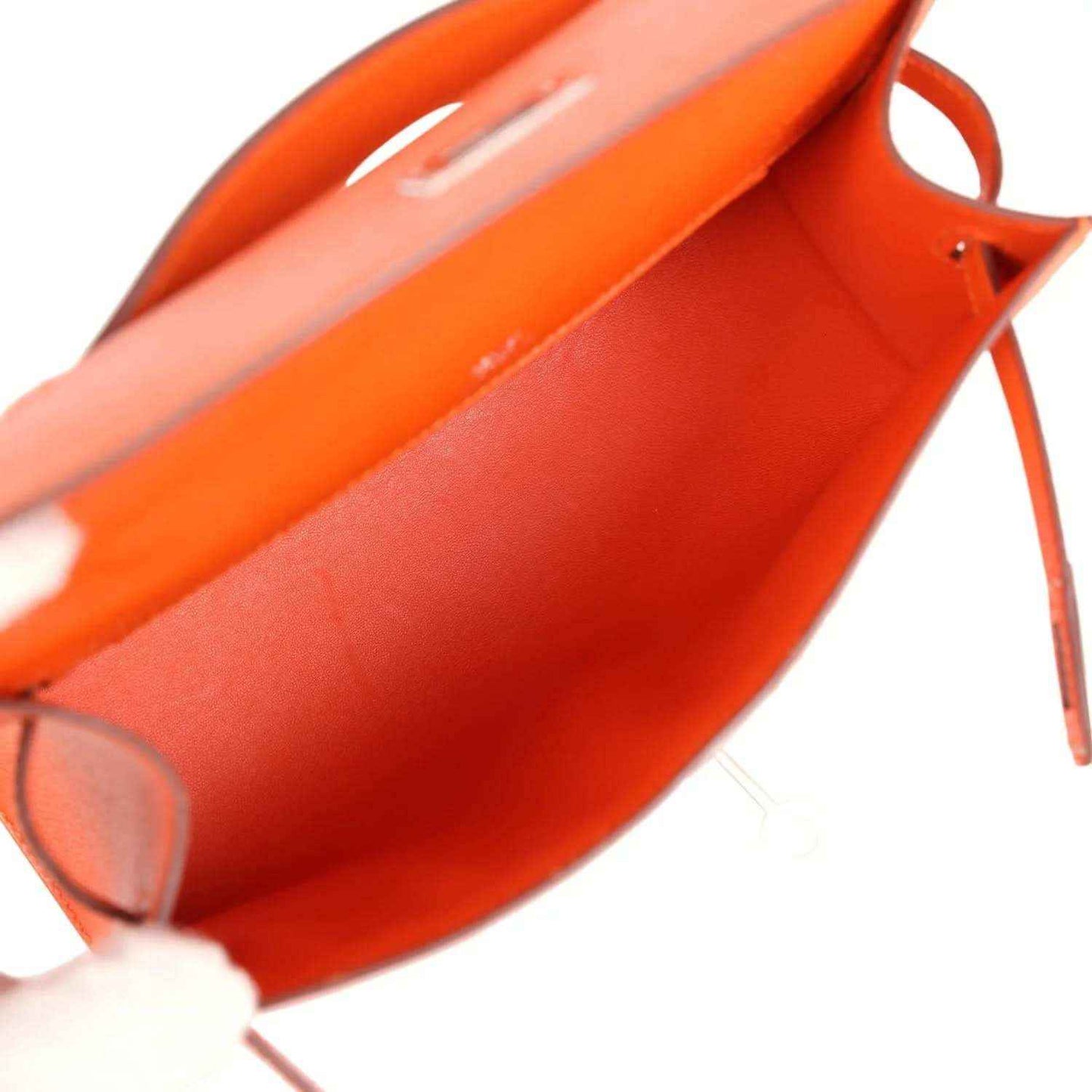 Orange Epsom leather clutch interior view with lining and open flap