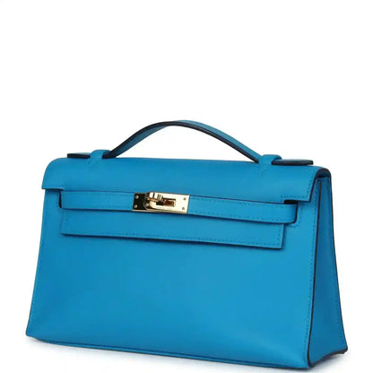 Hermes Kelly pochette handbag in blue with gold-tone front hardware