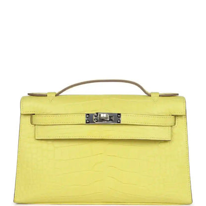 Lime alligator clutch with top handle, front flap and palladium-tone clasp