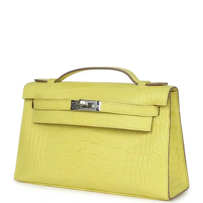 Lime alligator Kelly clutch with top handle, front flap and curved side