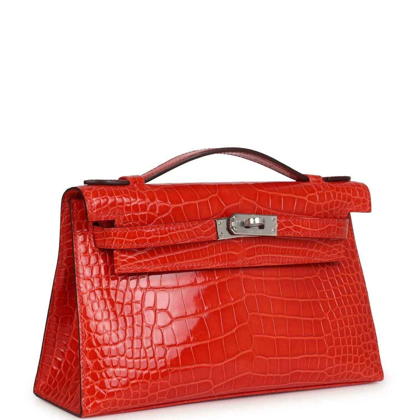 Orange crocodile-texture Kelly pochette with front flap, top handle, and clasp visible