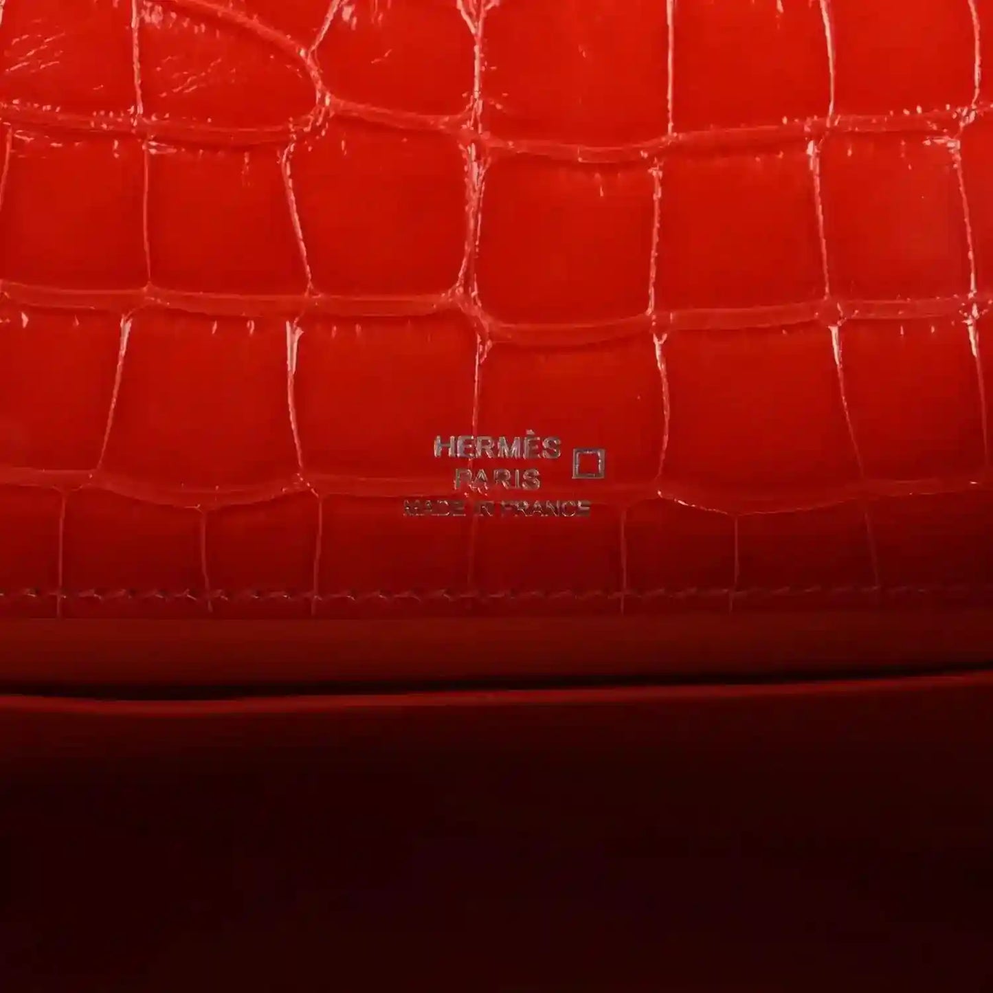 Orange crocodile-texture lining with embossed Hermes Paris mark