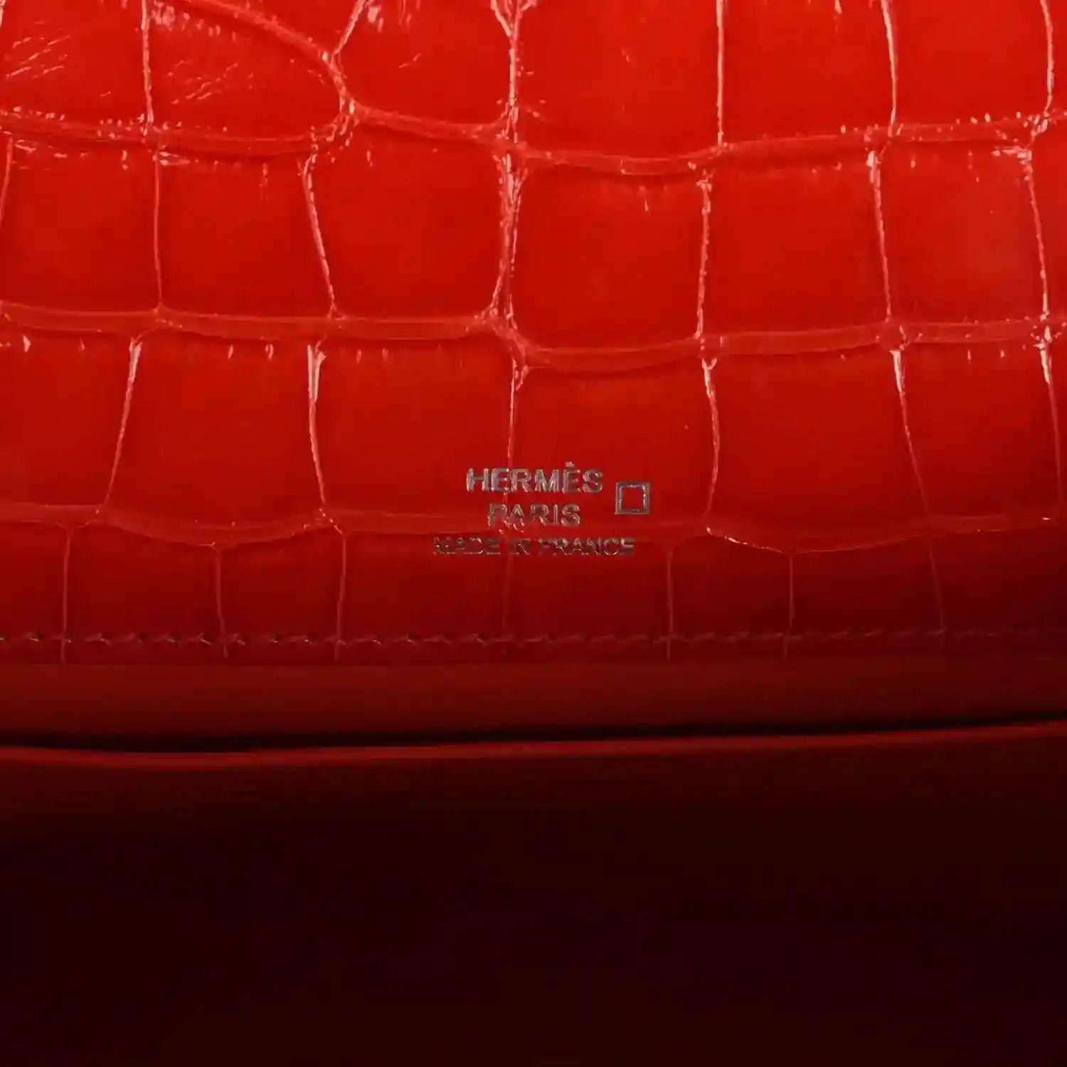 Orange crocodile-texture lining with embossed Hermes Paris mark