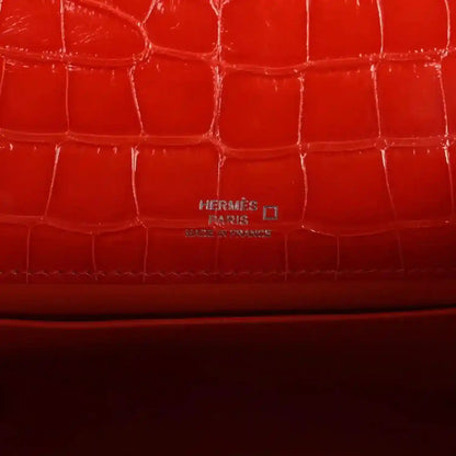 Orange crocodile-texture lining with embossed Hermes Paris mark